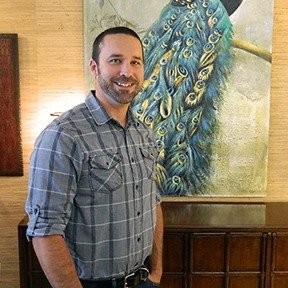 Owner of the business with a painting